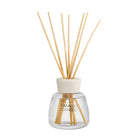 Yankee Candle reed diffuser with a clear glass bottle, natural wood reeds, and a cream-colored cap on a white background.