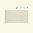 Bar of soap labeled 'Pure Vegetable Soap Made in England' with a weight indication on a beige background.