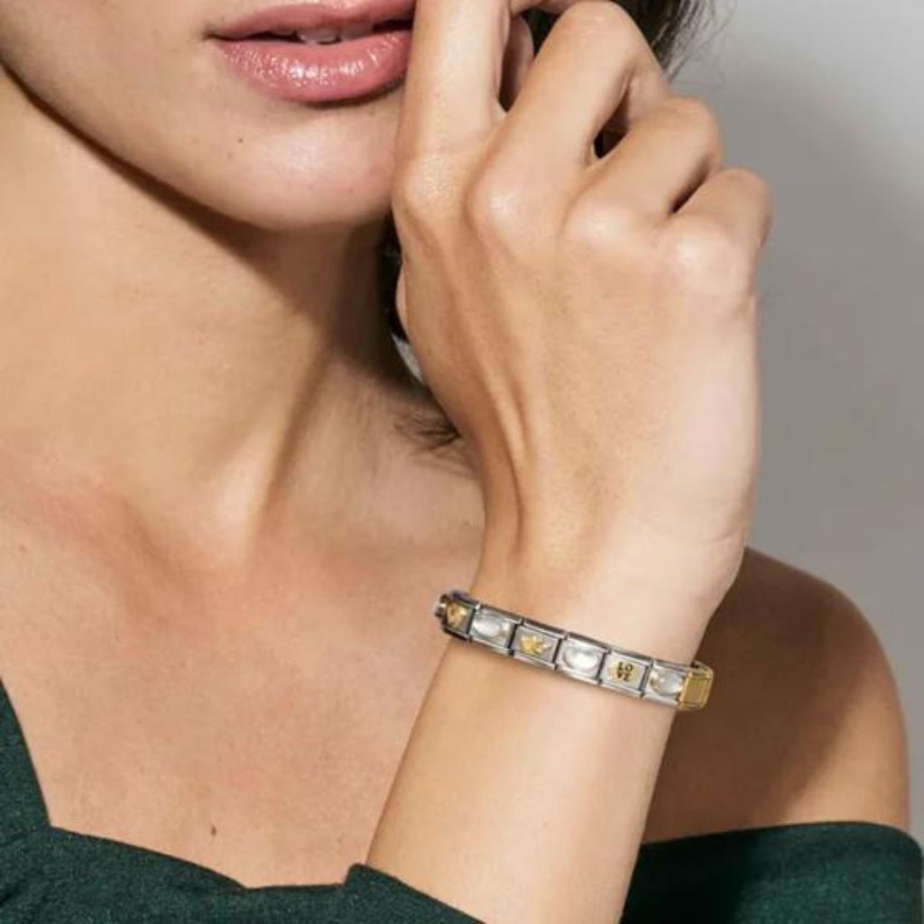 Close-up of a woman's hand wearing a bracelet with decorative elements.