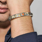 Close-up of a person's wrist wearing a Nomination Italy sterling silver and stainless steel bracelet with various symbols.