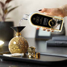 Cashmere Blankets Lamp Fragrance being poured into a Fragrance Lamp