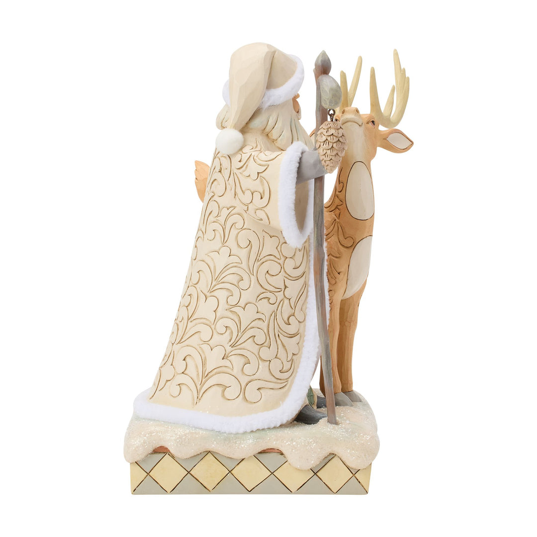 Decorative figurine of Santa Claus with a reindeer on a white background