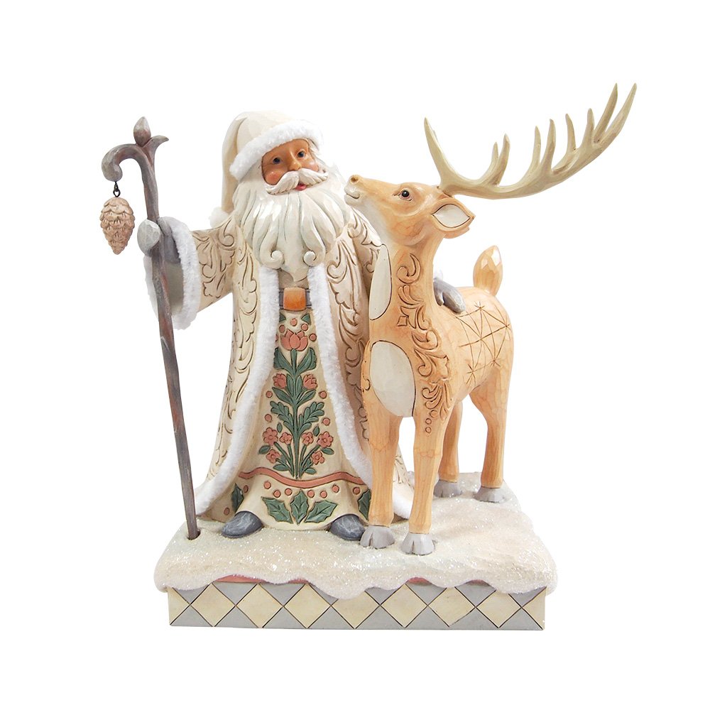 Decorative figurine of a traditional Santa Claus with a reindeer on a white background