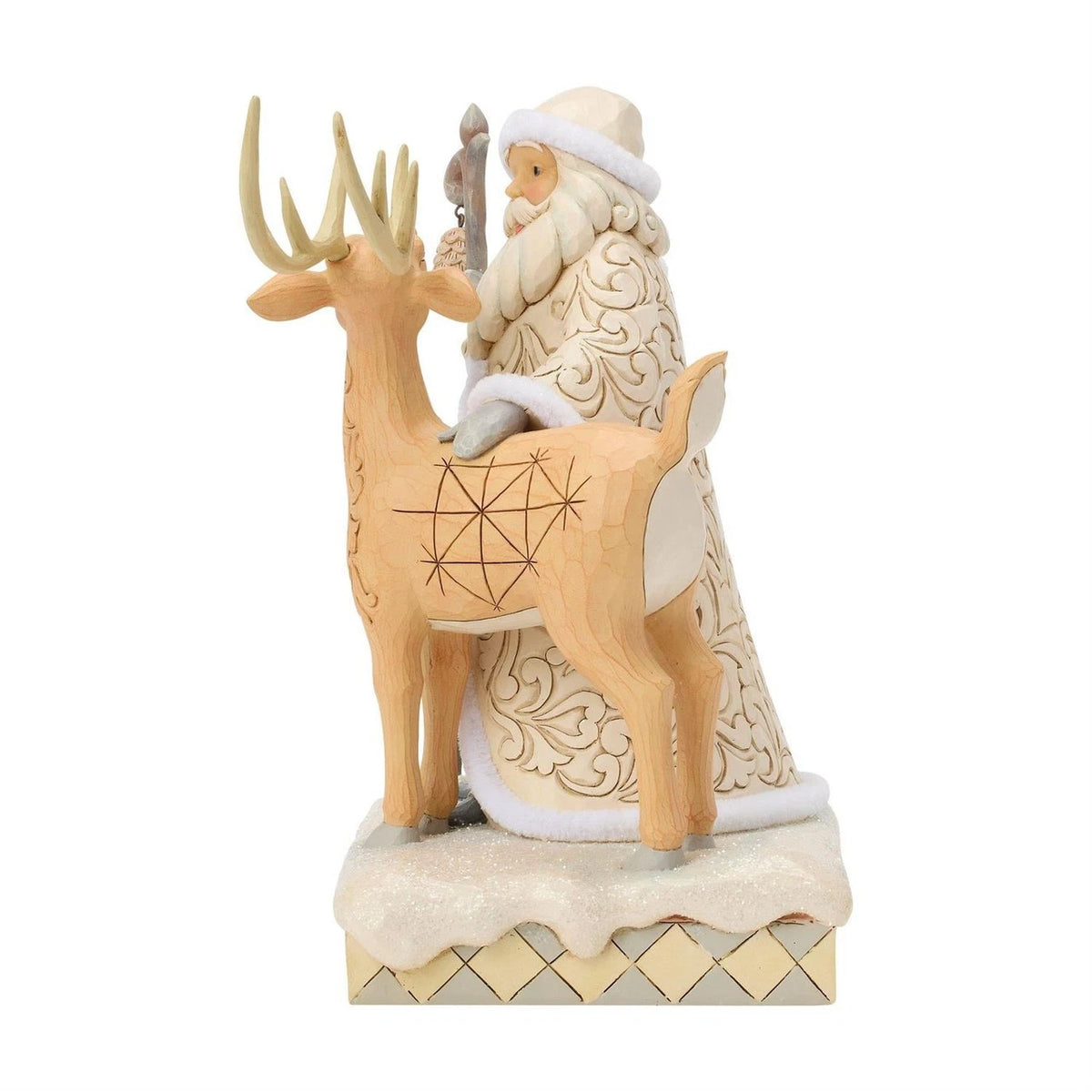 Decorative figurine of a Santa Claus standing beside a reindeer on a white background