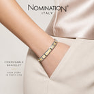 Close up image of a person wearing a nomination italy composable bracelet with multiple classic charms