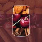 Image with almonds, cherries, and cinnamon sticks on a red background