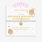 A Joma Jewellery bracelet displayed on its branded card. The bracelet is a delicate silver-plated beaded bracelet with a small pink and gold coloured cupcake charm.