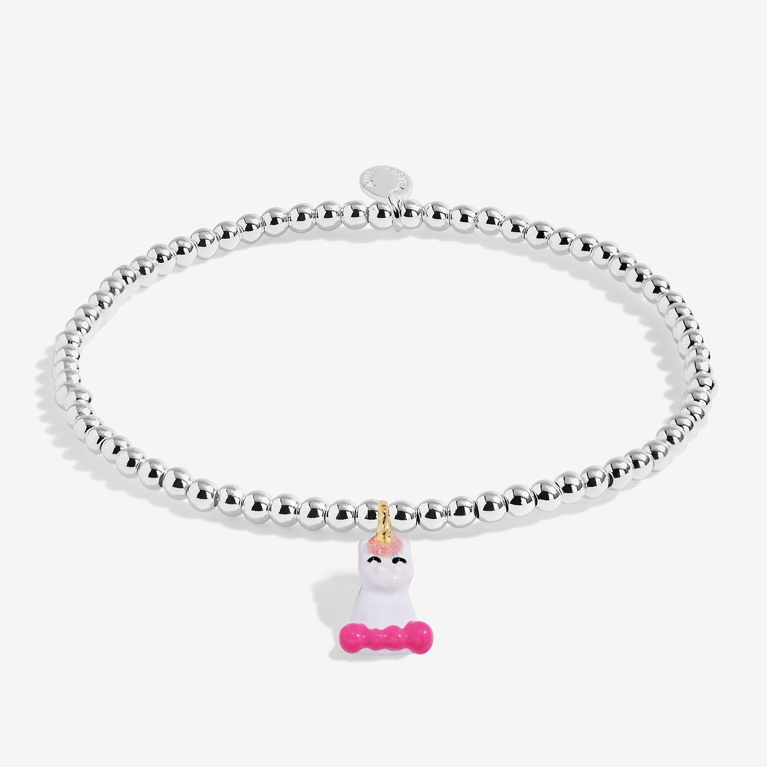 A silver-plated beaded stretch bracelet featuring a small white unicorn charm with a pink bow and gold horn, displayed on a clean white background.