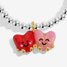Bracelet with red and pink heart-shaped charms on a white background