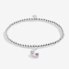 Silver-plated bracelet with a white moon & star charm on a white background