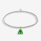 A silver-plated beaded bracelet with a green Christmas tree charm featuring gold accents, displayed on a light gray background.