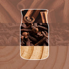 Image showing a yankee candle shaped jar cut out with cinnamon sticks and cloves design on a brown background