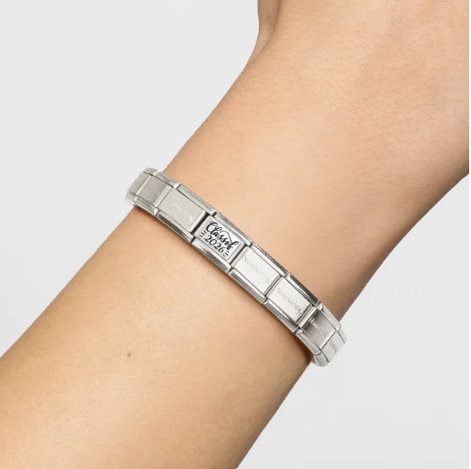 Nomination Italy Stainless Steel  bracelet with a Class of 2026 charm in Sterling Silver on a person's wrist with a light gray background