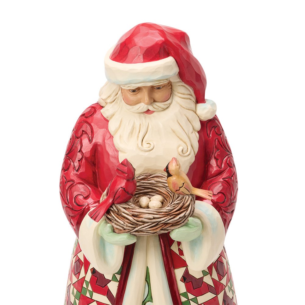 close of Santa Claus figurine holding a nest with eggs on a white background