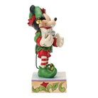 Decorative mickey Mouse figurine in festive Elf attire holding a train on a white background