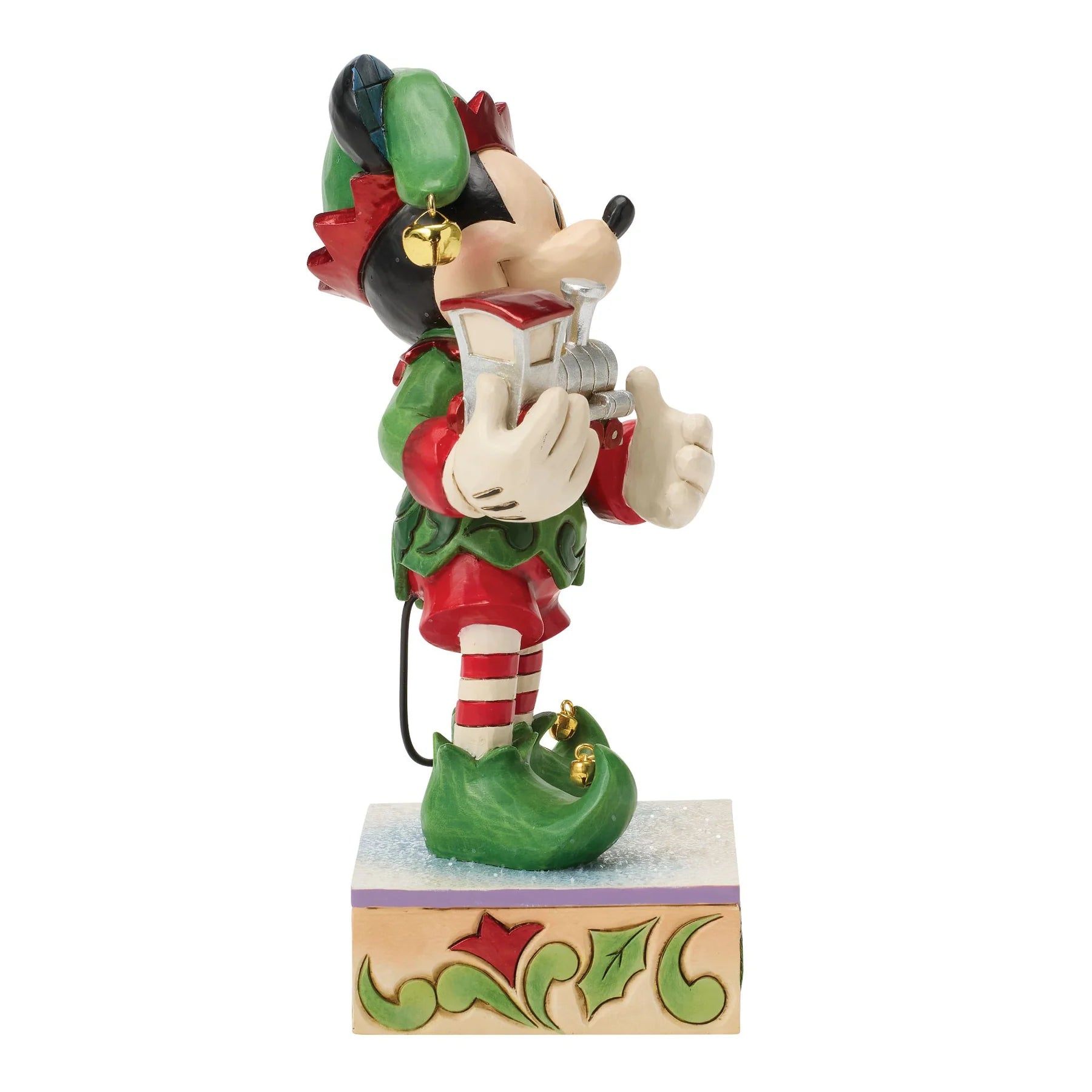 Decorative mickey Mouse figurine in festive Elf attire holding a train on a white background
