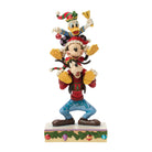 Donald, Mickey Mouse &  Goofy all piled up on each others shoulders stood on a decorative plinth