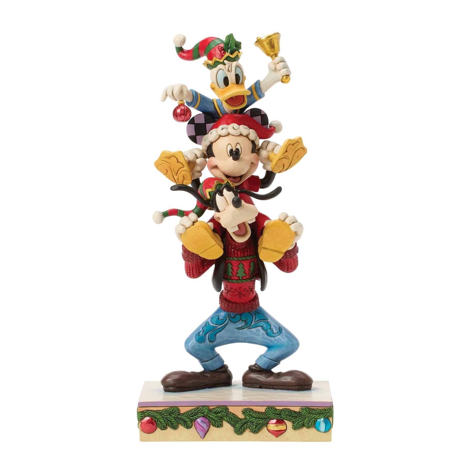 Donald, Mickey Mouse &  Goofy all piled up on each others shoulders stood on a decorative plinth