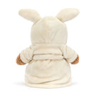 Plush jellycat Bartholomew teddy bear wearing a cream bathrobe on a white background