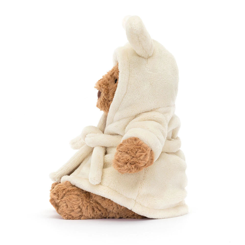 jellycat Bartholomew teddy Teddy bear wearing a cream robe on a white background facing to the right