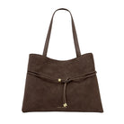 Brown suede handbag with a drawstring on a white background
