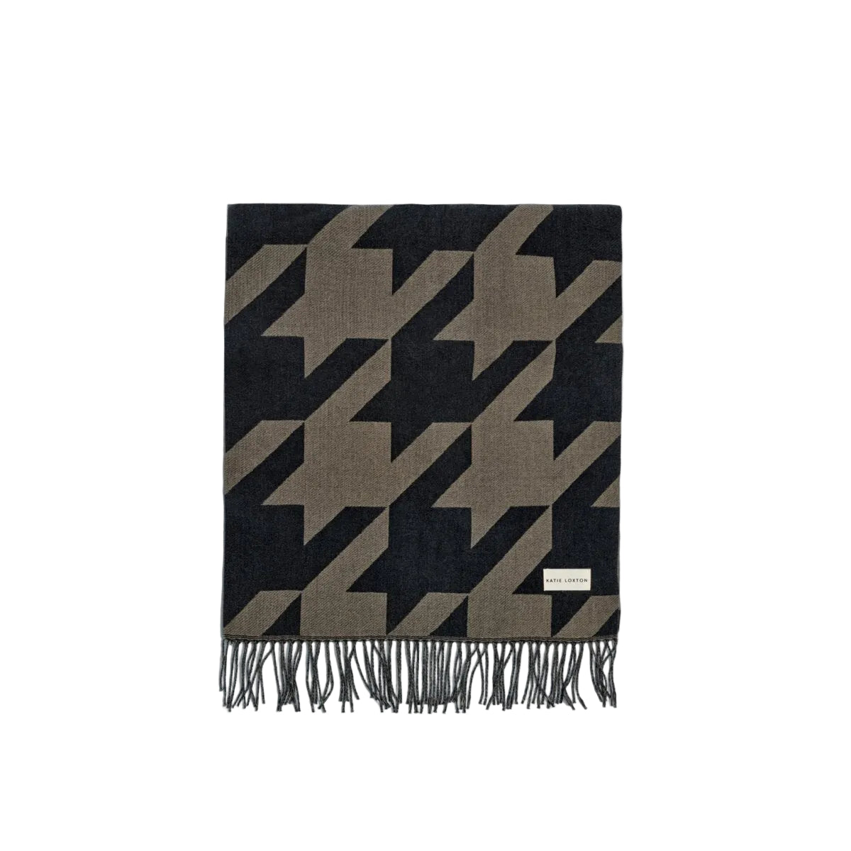 A folded woven scarf with a houndstooth pattern in black and taupe, featuring fringed edges and a small white brand label near the bottom right.