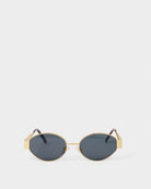 siena katie loxton Gold-framed sunglasses with dark lenses on a white background