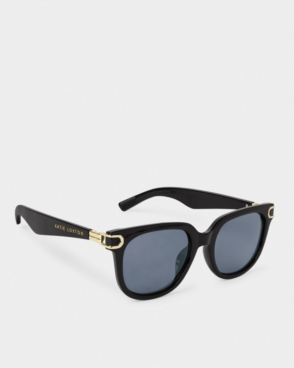 Black Katie Loxton Manhattan sunglasses with gold accents on a white background