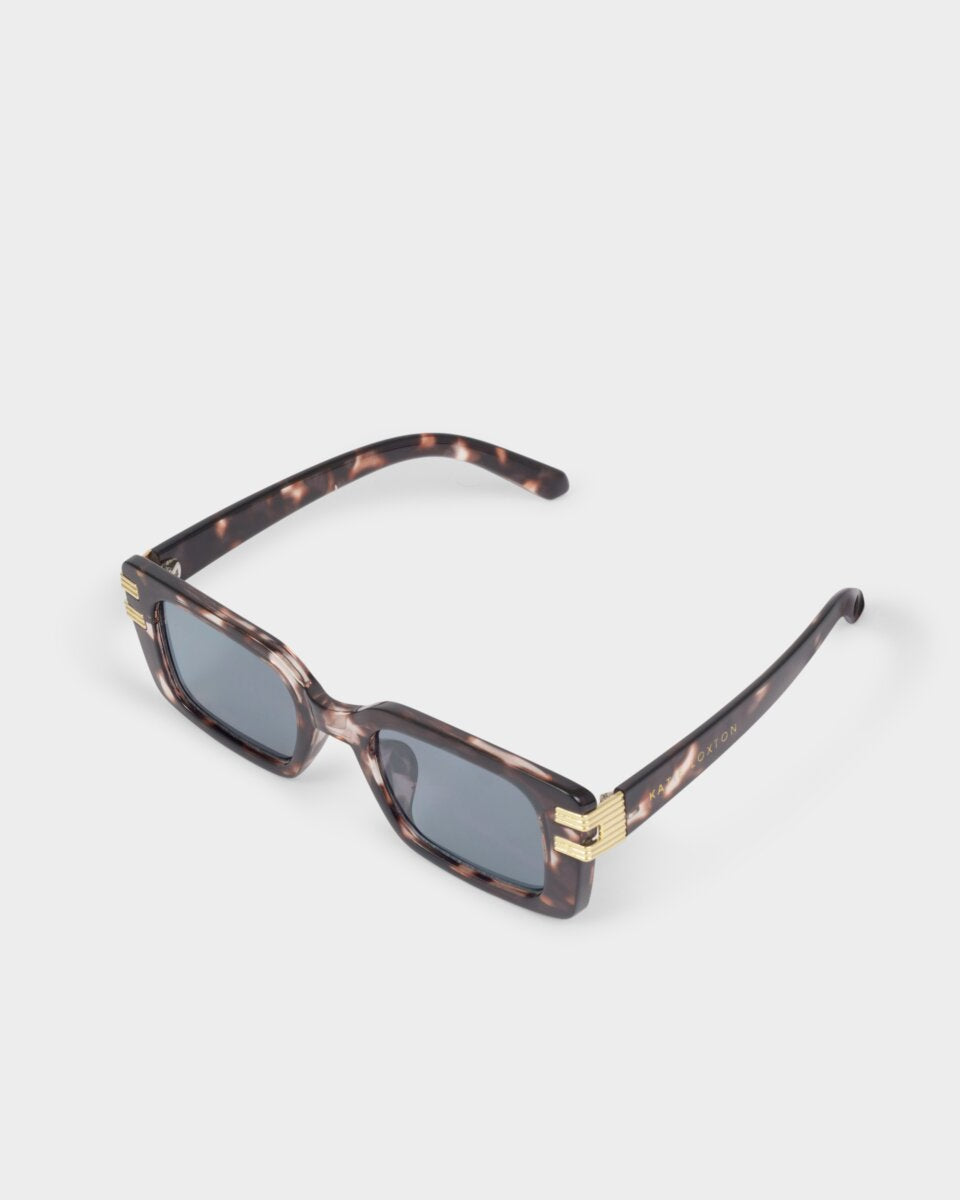 katie loxton malibu tortoiseshell Sunglasses with tortoiseshell frame and gold accents on a white background