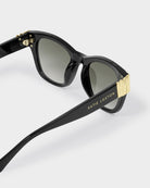 katie loxton seychelles Black sunglasses with gold accents on a white background