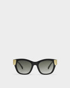 katie loxton seychelles Black sunglasses with gold accents on a white background