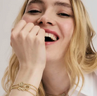 Woman with blonde hair wearing Nomination Italy Soffio A'more jewellery. On a plain background to advertise the collection