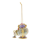 A decorative hanging ornament shaped like a teacup and saucer from Beauty and the Beast, with a gold hanging string, shown on a plain white background.
