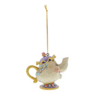 A decorative hanging ornament featuring mrs potts, the cream-colored body with pastel purple, yellow, pink, and blue painted accents, suspended by a gold string on a plain white background.
