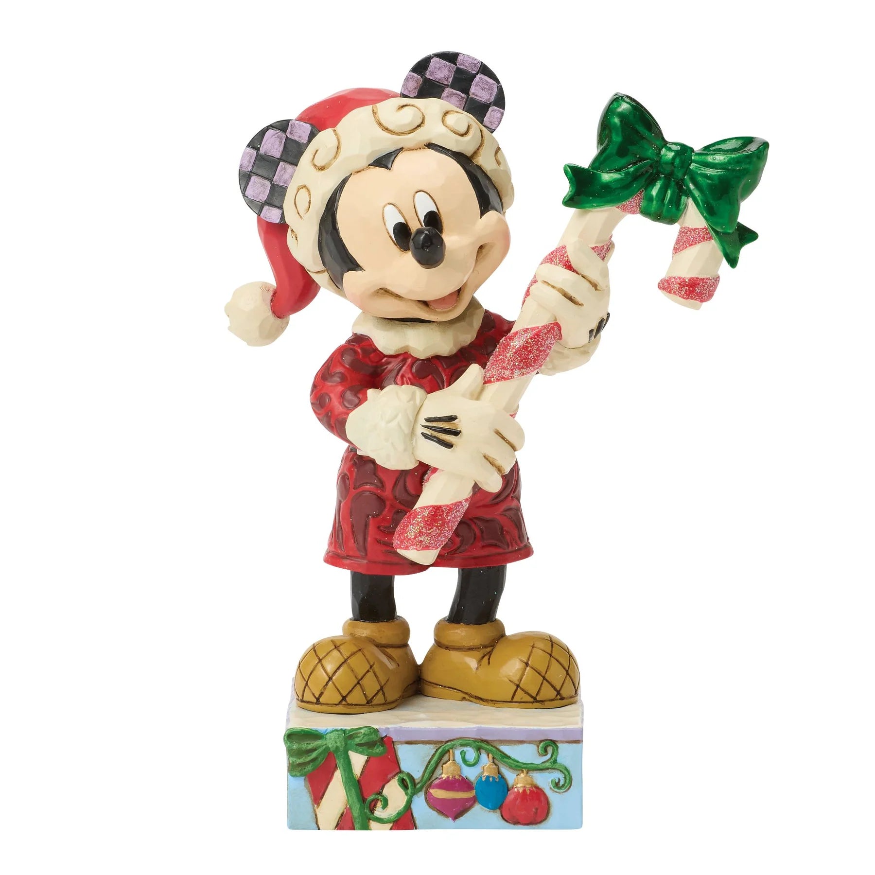 Christmas-themed Mickey Mouse figurine of a character holding candy canes on a white background