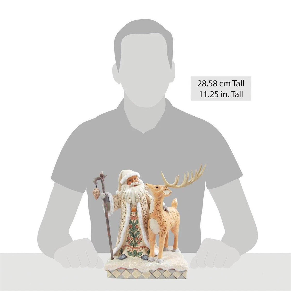 Statue of a Santa Claus figure with a deer, shown next to a person for scale on a white background.