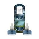Yankee Candle Bayside Cedar scent refill set, featuring two blue glass refill bottles with white caps placed in front of their branded packaging box on a solid white background.