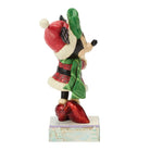 Minnie Mouse figurine with a red hat and green cape on a white background
