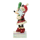 Minnie Mouse Figurine of a character in a Santa outfit holding a snowflake and green item on a white background
