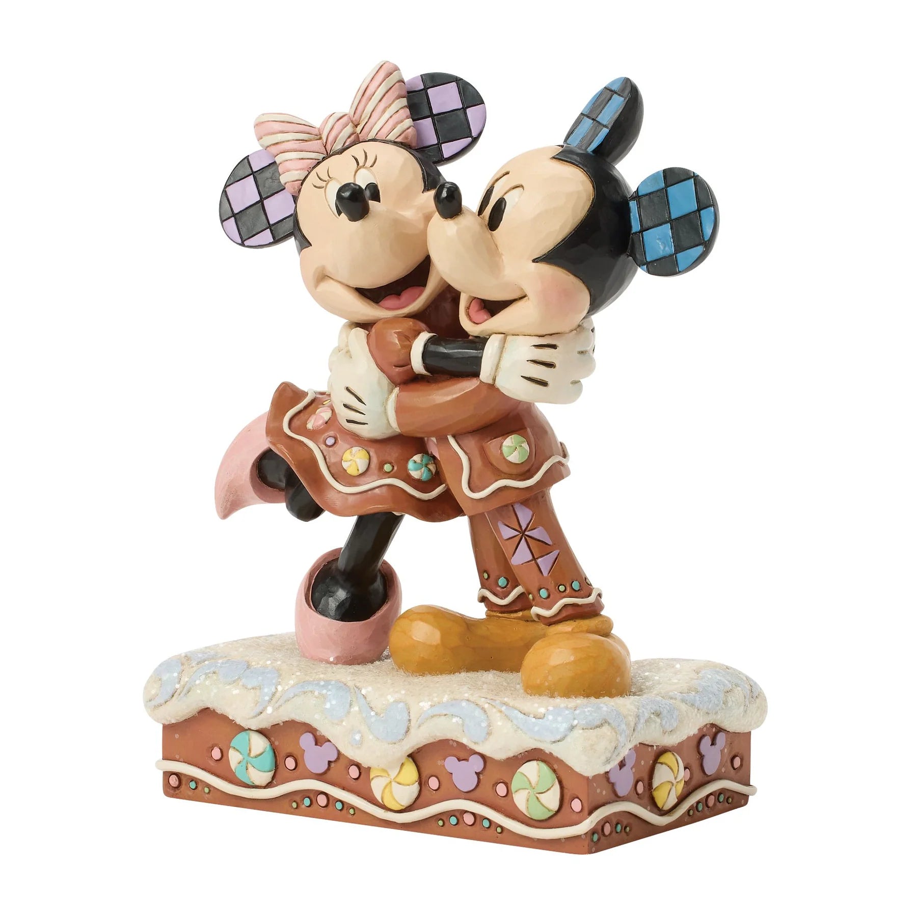 Statue of Mickey and Minnie Mouse embracing on a decorative base with a white background