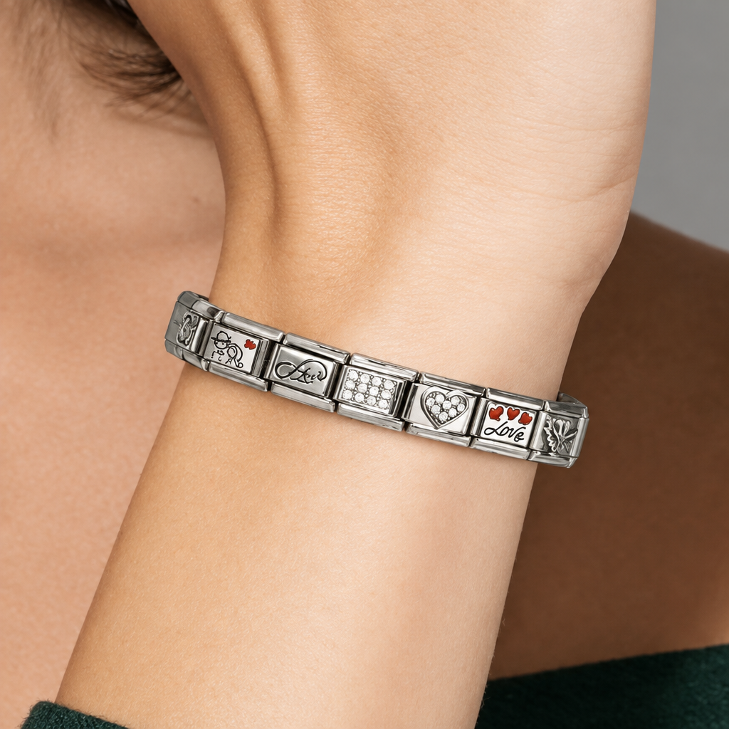 Silver bracelet with engraved symbols on a wrist against a neutral background